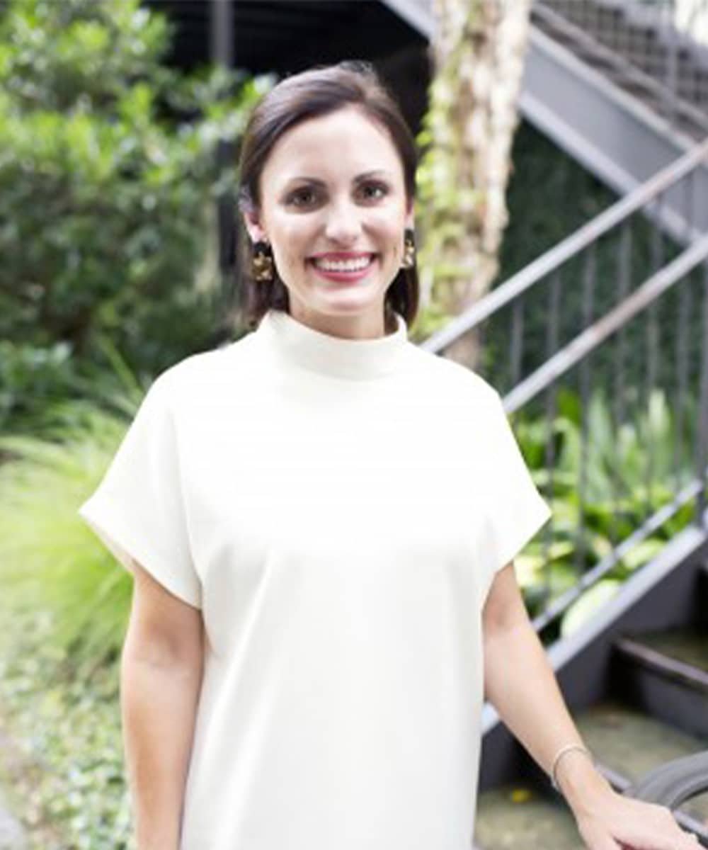 a person standing in front of a fence