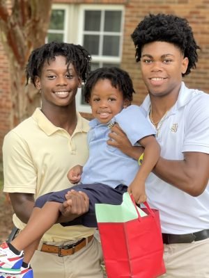 A Group Of People Posing For The Camera