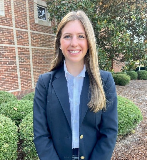 a person standing in front of a brick building