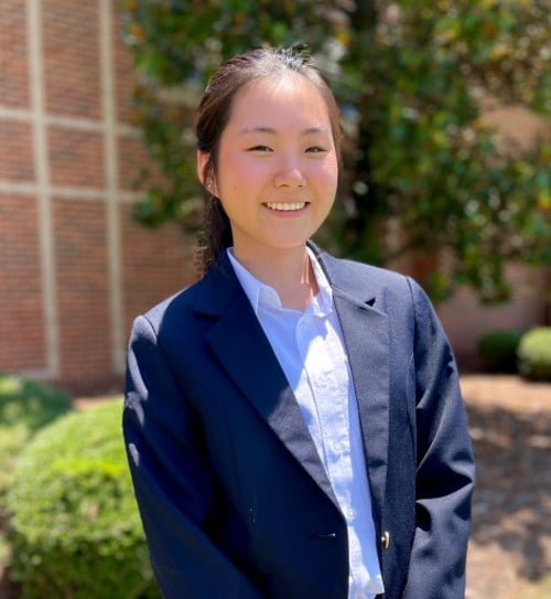 a young man wearing a suit and tie
