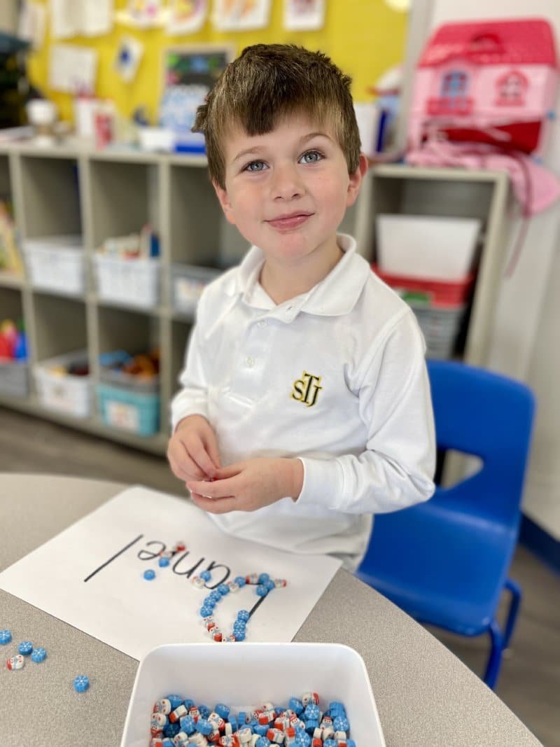 a little boy sitting at a table